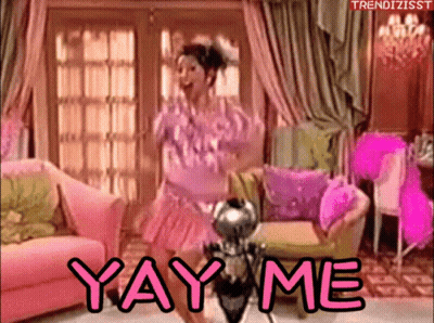 A Woman In A Pink Dress Is Dancing In A Living Room With The Words Yay Me Written On The Bottom GIF