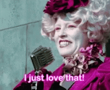 A Woman In A Pink Dress Is Holding A Microphone And Saying `` I Just Love That '' . GIF