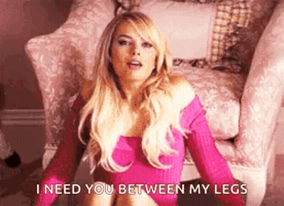 A Woman In A Pink Dress Is Sitting In A Chair . GIF