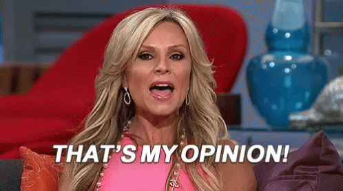 A Woman In A Pink Dress Is Sitting On A Couch And Saying That 'S My Opinion . GIF
