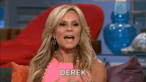 A Woman In A Pink Dress Is Sitting On A Couch And Talking To Someone . GIF