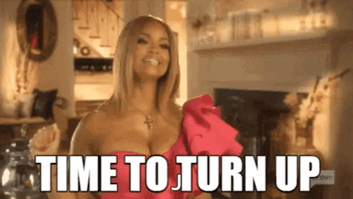A Woman In A Pink Dress Is Smiling And Says Time To Turn Up GIF