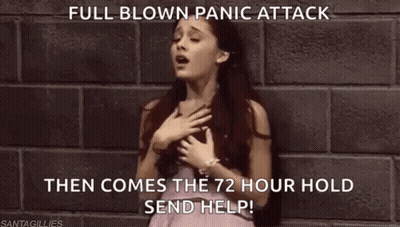 A Woman In A Pink Dress Is Standing In Front Of A Brick Wall With Her Hand On Her Chest . GIF