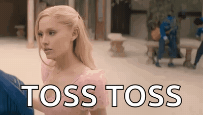 A Woman In A Pink Dress Is Standing Next To A Man In A Blue Shirt And Says `` Toss Toss '' . GIF