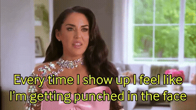 A Woman In A Pink Dress Is Talking About Getting Punched In The Face GIF