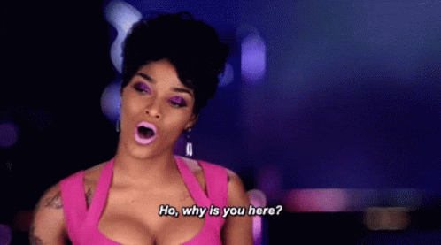 A Woman In A Pink Dress Is Talking To Someone . GIF