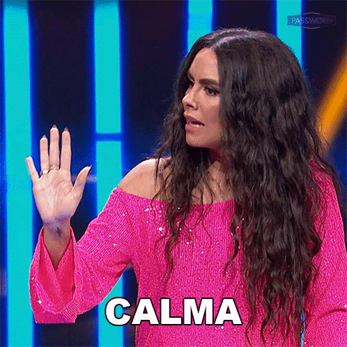 A Woman In A Pink Dress Says Calma With Her Hand Up GIF