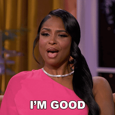 A Woman In A Pink Dress Says I 'M Good With Her Tongue Out GIF