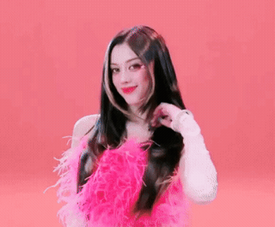 A Woman In A Pink Dress With Feathers On It GIF