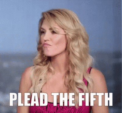 A Woman In A Pink Dress With Plead The Fifth Written Above Her GIF