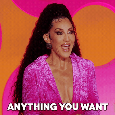 A Woman In A Pink Dress With The Words Anything You Want Below Her GIF