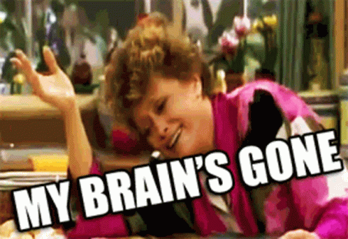 A Woman In A Pink Jacket Is Laying At A Table With The Words " My Brain 'S Gone " Above Her GIF