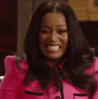 A Woman In A Pink Jacket Is Making A Funny Face And Looking At The Camera . GIF