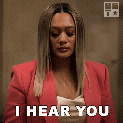 A Woman In A Pink Jacket Is Saying I Hear You GIF