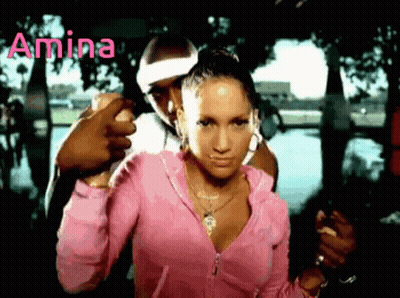 A Woman In A Pink Jacket Is Standing Next To A Man With The Word Amina Written On The Bottom GIF