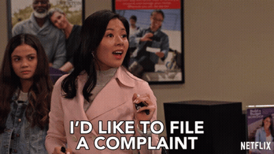 A Woman In A Pink Jacket Says " I 'D Like To File A Complaint " GIF