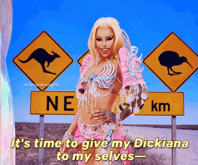 A Woman In A Pink Outfit Stands In Front Of A Sign That Says Ne Km GIF