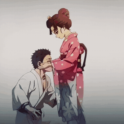 A Woman In A Pink Polka Dot Kimono Is Touching The Face Of A Man GIF