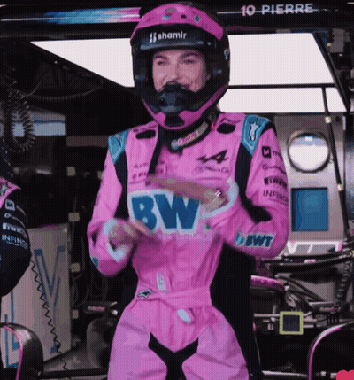 A Woman In A Pink Racing Suit With Bw Written On The Front GIF