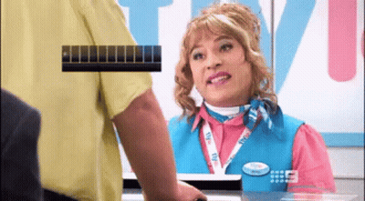A Woman In A Pink Shirt And Blue Vest Is Talking To A Man GIF