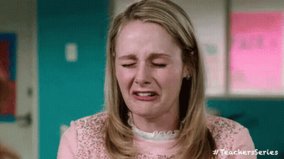A Woman In A Pink Shirt Is Crying And Making A Funny Face With Her Eyes Closed . GIF