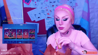 A Woman In A Pink Shirt Is Eating A Chicken Nugget While Watching A Video GIF