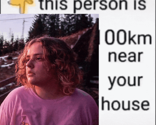 A Woman In A Pink Shirt Is Next To A Sign That Says This Person Is 100Km Near Your House GIF