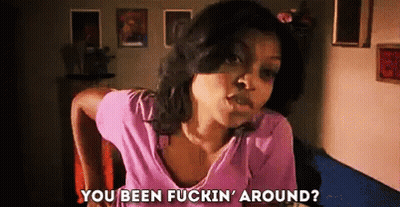 A Woman In A Pink Shirt Is Sitting In A Chair And Talking To Someone . GIF
