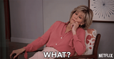 A Woman In A Pink Shirt Is Sitting In A Chair With The Words What On The Bottom GIF