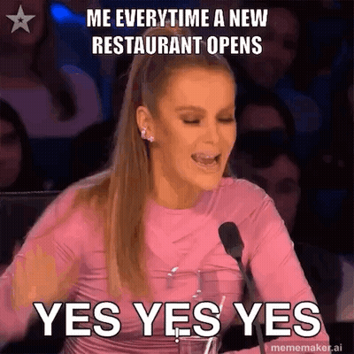 A Woman In A Pink Shirt Is Sitting In Front Of A Microphone And Making A Funny Face . GIF