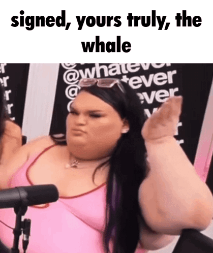 A Woman In A Pink Shirt Is Sitting In Front Of A Microphone With The Words Signed Yours Truly The Whale GIF