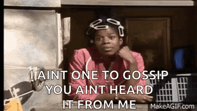 A Woman In A Pink Shirt Is Sitting In Front Of A Window And Talking To Someone . GIF
