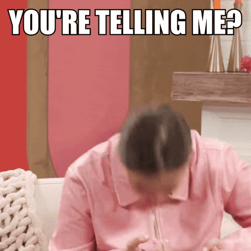 A Woman In A Pink Shirt Is Sitting On A Couch With The Words You 'Re Telling Me Behind Her GIF