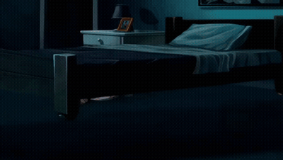 A Woman In A Pink Shirt Is Standing In A Dark Room Next To A Bed GIF