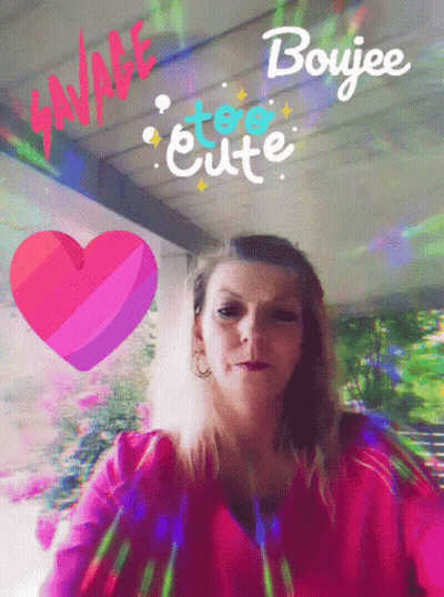 A Woman In A Pink Shirt Is Surrounded By A Heart And The Words " Savage Too Cute " GIF