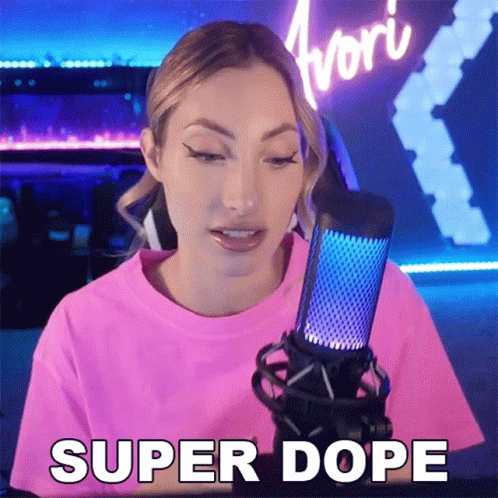 A Woman In A Pink Shirt Is Talking Into A Microphone And Saying Super Dope GIF