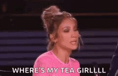 A Woman In A Pink Shirt Is Talking Into A Microphone And Saying `` Where 'S My Tea Girl ? '' GIF