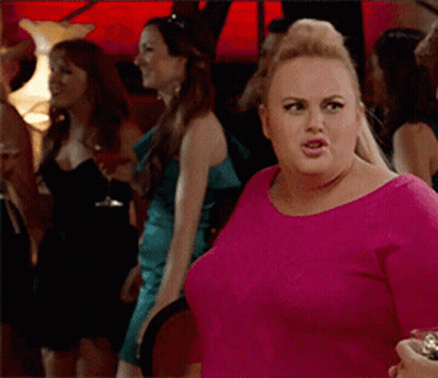A Woman In A Pink Shirt Stands In A Crowd Of Women GIF