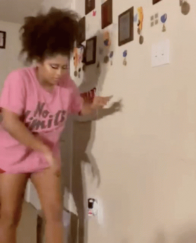 A Woman In A Pink Shirt That Says No Limits GIF