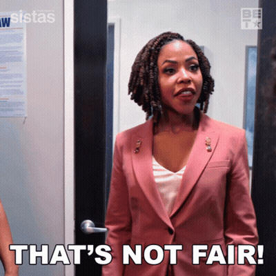 A Woman In A Pink Suit Has The Words That 'S Not Fair On Her Chest GIF