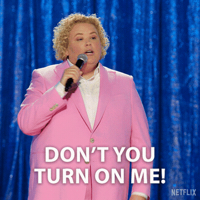 A Woman In A Pink Suit Is Holding A Microphone And Saying " Don 'T You Turn On Me " GIF