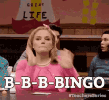 A Woman In A Pink Sweater Is Sitting At A Table With Her Hands In Her Hair And Says B-B-B-Bingo . GIF