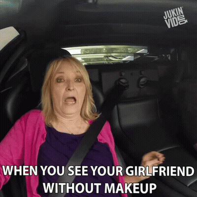 A Woman In A Pink Sweater Is Sitting In A Car With A Caption That Says When You See Your Girlfriend Without Makeup GIF
