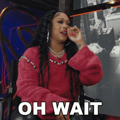 A Woman In A Pink Sweater Is Sitting In A Chair With The Words " Oh Wait " On The Bottom GIF