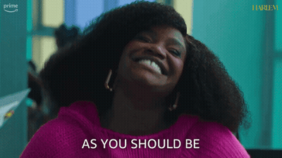 A Woman In A Pink Sweater Is Smiling And Says As You Should Be GIF