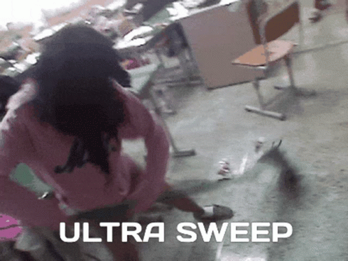 A Woman In A Pink Sweater Is Standing In A Room With The Words Ultra Sweep Written On The Floor GIF