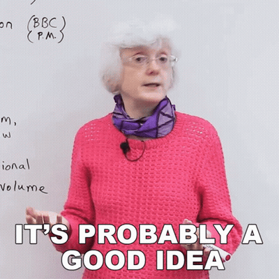 A Woman In A Pink Sweater Says It 'S Probably A Good Idea In Front Of A White Board GIF