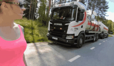 A Woman In A Pink Tank Top Looks At A Scania Truck GIF