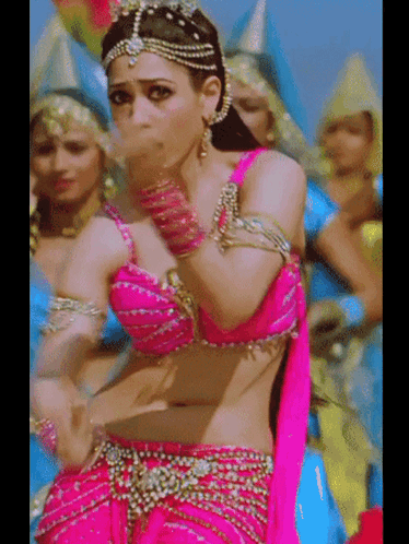 A Woman In A Pink Top Is Dancing In Front Of Other Women GIF