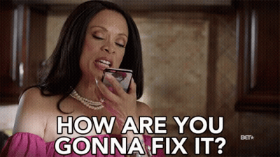 A Woman In A Pink Top Is Holding A Cell Phone And Says How Are You Gonna Fix It GIF